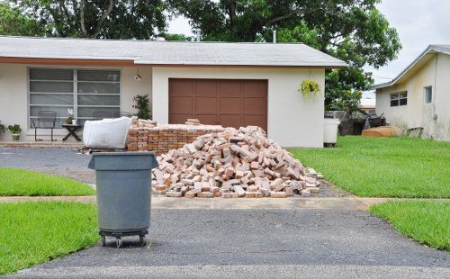 Photograph of garden waste piles and removal crew
